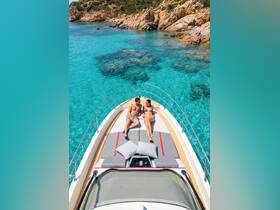 A couple enjoys sunbathing on the bow of a boat, surrounded by crystal-clear waters and stunning rocky landscapes — an idyllic setting for a romantic getaway.