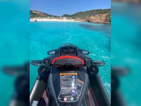 A close-up view of a Sea-Doo jet ski ready for adventure in crystal-clear waters, perfect for thrilling water sports experiences.