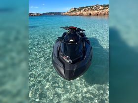 A sleek jet ski glides through crystal-clear waters, perfect for thrilling water adventures in stunning coastal landscapes.
