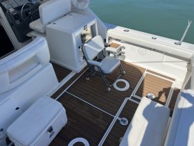 An interior view of a boat's helm and seating area, showcasing a clean and functional design, perfect for comfortable navigation and relaxation.