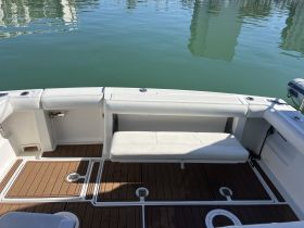 Interior view of a boat's seating area, showcasing a clean and spacious layout ideal for relaxation and comfort on the water.