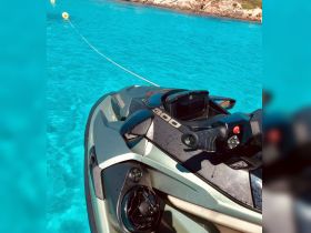 A close-up view of a sleek jet ski resting in crystal-clear turquoise waters, perfect for thrilling water adventures.