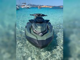 A sleek jet ski sits in crystal-clear waters, perfect for thrilling water adventures and exploring coastal destinations.