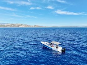 A group enjoys a day on the water aboard a boat, surrounded by stunning ocean views — perfect for adventure and relaxation.