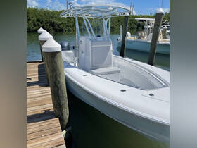 A sleek center console boat docked at a marina, showcasing its modern design and ready for a day on the water.