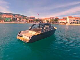 A sleek yacht is anchored in calm waters, showcasing its modern design against a picturesque coastal backdrop.