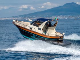 A sleek speedboat navigates the waters near Mount Vesuvius, showcasing its elegant design and performance. Perfect for exploring the stunning Amalfi Coast.