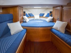 Cozy interior cabin of a boat featuring comfortable seating and a relaxing lounge area, perfect for unwinding during your nautical adventures.