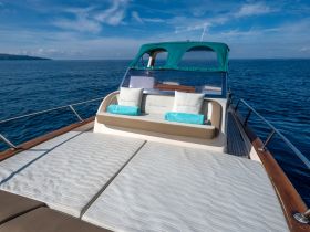 A serene view of the lounge area on a yacht, featuring comfortable seating and a tranquil ocean backdrop — perfect for relaxation on the water.