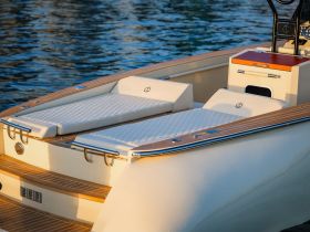 A stylish interior view of a boat's lounge area featuring plush seating, perfect for relaxing on the water.