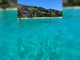 A stunning view of crystal-clear turquoise waters and a picturesque beach, perfect for showcasing the beauty of tropical destinations.