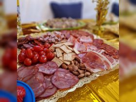 A beautifully arranged charcuterie platter featuring a variety of meats, cheeses, and snacks, perfect for enjoying on a boat trip or gathering.