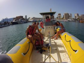 A lively group enjoys their time on a boat, showcasing smiles and excitement as they prepare for a fun day on the water.