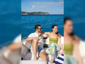 A couple enjoys a sunny day on a boat, surrounded by stunning ocean views — perfect for romantic getaways or relaxing outings on the water.