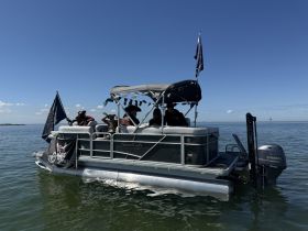 A lively group enjoys a day on a pontoon boat, showcasing the fun and camaraderie of on-water adventures.