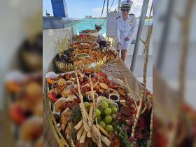 A beautifully arranged charcuterie spread on a yacht, featuring a variety of snacks and treats, perfect for enhancing any boating experience.