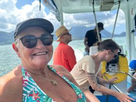 A joyful group enjoys their time on a boat, capturing the essence of adventure and camaraderie on the water.