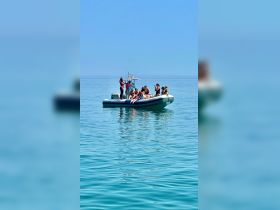 A lively group enjoys a day on the water aboard a boat, capturing fun moments under the sun — perfect for summer adventures and celebrations.