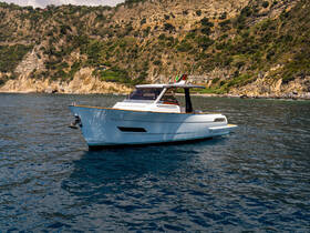 A sleek yacht glides through clear waters, showcasing its elegant design against a stunning coastal backdrop — perfect for luxury cruising.