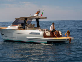 A couple enjoys a sunny day on a stylish boat, with one person dipping their feet in the water — perfect for summer adventures and relaxation on the sea.