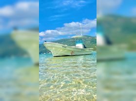A pristine view of a boat named 'BATNAVOI' anchored in clear waters, showcasing the beauty of a serene marine environment.
