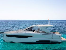 A sleek yacht glides through crystal-clear waters, showcasing its elegant design and luxurious features — perfect for upscale boating experiences.