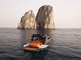 A stunning yacht anchored near dramatic rock formations, showcasing the beauty of coastal scenery — perfect for luxury getaways and exploration.