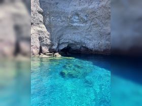 A stunning view of a coastal cave surrounded by crystal-clear waters, perfect for exploring and enjoying the natural beauty of the area.
