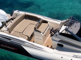 An inviting interior view of a luxury boat featuring spacious seating and a well-equipped helm, perfect for comfortable cruising on the water.