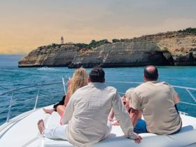 A group of friends enjoys a scenic boat ride along a stunning coastline, capturing the essence of adventure and relaxation on the water.