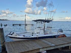 A sleek fishing speedboat docked at the pier, showcasing its fishing rods and ready for an adventure on the water.