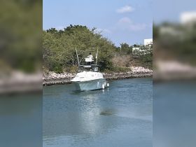 A sleek speedboat navigates through calm waters, showcasing its design and functionality — perfect for fishing or leisure outings.