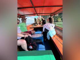 Inside view of a boat with guests enjoying the ride, showcasing the seating area and cabin space. Perfect for family outings and group adventures on the water.