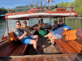 A cheerful group enjoys their time aboard a boat, showcasing a fun and relaxed atmosphere perfect for exploring scenic waterways.