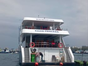 The Kaani Princess yacht is docked, showcasing its spacious design and inviting seating areas, perfect for group outings and tours.