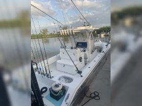 An interior view of a fishing boat showcasing the helm and fishing gear, perfect for anglers looking to enjoy a day on the water.