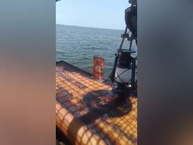 An interior view of a boat featuring a decorative table with a pirate theme and a lantern, showcasing the unique ambiance of the vessel.