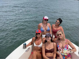 A fun group of friends enjoys a day on the water, showcasing the perfect atmosphere for a summer celebration aboard a boat.