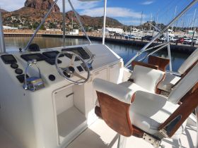 A well-equipped helm area featuring modern controls and comfortable seating, perfect for navigating the waters in style.