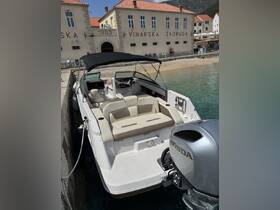 A well-appointed interior view of a boat featuring comfortable seating and a helm, perfect for relaxing on the water.
