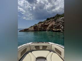 A serene view from the bow of a boat, showcasing the tranquil turquoise waters and rocky coastline, perfect for exploring hidden coves and enjoying nature.