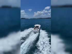 A sleek speedboat cuts through the vibrant blue waters, showcasing the thrill of a day on the water. Perfect for adventure seekers looking to explore coastal destinations.
