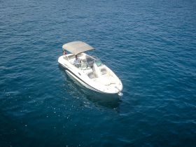 Aerial view of a sleek speedboat cruising through deep blue waters, showcasing the perfect vessel for thrilling adventures on the sea.