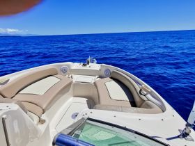 A well-appointed interior view of a boat's helm and seating area, showcasing comfort and style for a perfect day on the water.