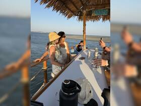 A lively group enjoys drinks at a boat bar, capturing moments of fun and celebration on the water. Perfect for social gatherings and memorable outings.