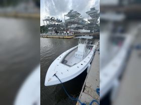 A sleek speedboat docked at a marina, showcasing its modern design and ready for adventure on the water.