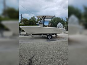 A pristine center console boat is showcased, docked and ready for adventure, highlighting its sleek design and features.