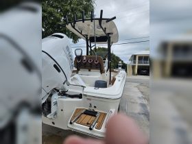 A detailed view of the helm and seating area of a well-equipped boat, showcasing the modern console and comfortable seating, perfect for a day on the water.