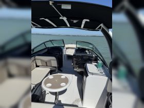 A spacious interior view of a modern boat featuring comfortable seating and a well-equipped helm, perfect for enjoying a day on the water.