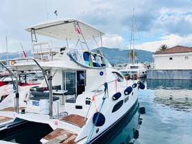 A sleek yacht docked in a marina, showcasing its stylish exterior and inviting deck space — perfect for luxury getaways or family outings.